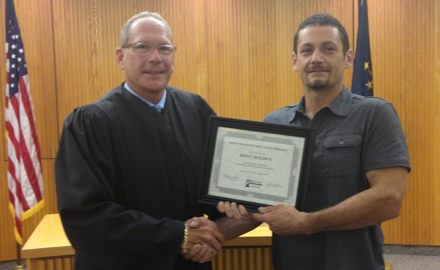 Judge Michael Reed congratulates Kent Holden, the first graduate of the Kosciusko County Drug Court program.