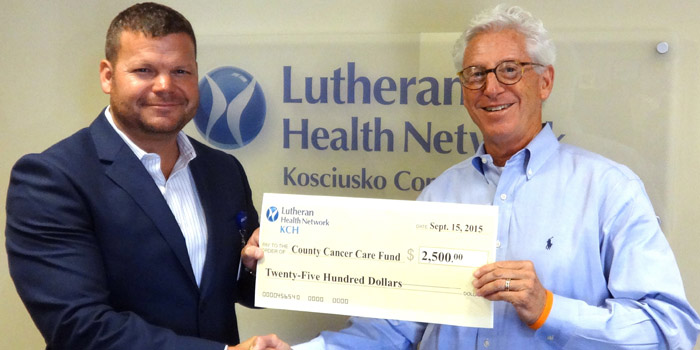 Kirk Ray, new CEO for The Lutheran Health Network/KCH presents a check to Ron Smock, organizer of a new fundraiser for the Cancer Care Fund of Kosciusko County.