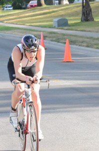 A competitor nears the finish line in Winona Lake Park during the biking portion of the Warsaw Optimist Triathlon last year. (File photo) 