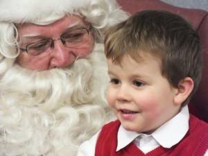 Rayven Slone enjoys his visit with Santa at the Milford Public Library on Thursday, Dec. 13. (Photo provided by Mike Ginter)