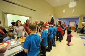 Volunteer students from Eisenhower Elementary School help served dinner Wednesday night for Fellowship Missions. (Photo by Al Disbro)