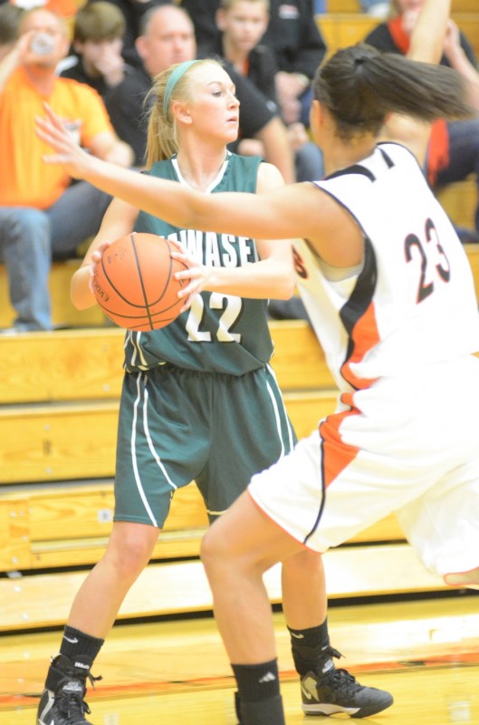 Wawasee standout KiLee Knafel is guarded closely by Jennifer Walker-Crawford of Warsaw Saturday night. Knafel scored 16 points to lead the Warriors.