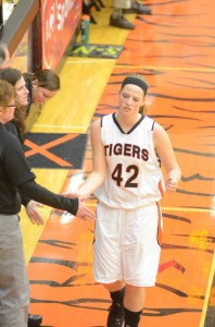 Nikki Grose is congratulated by coach Michelle Harter during the Lady Tiger Classic Thursday. Grose had two impressive games in earning all-tourney honors for the champion Tigers.