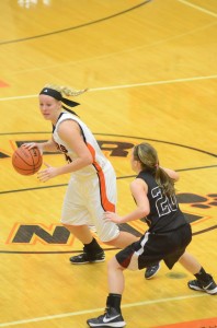 Warsaw senior Lindsay Baker moves past a Lowell defender Thursday night. Baker had 17 points to help the Tigers remain undefeated.