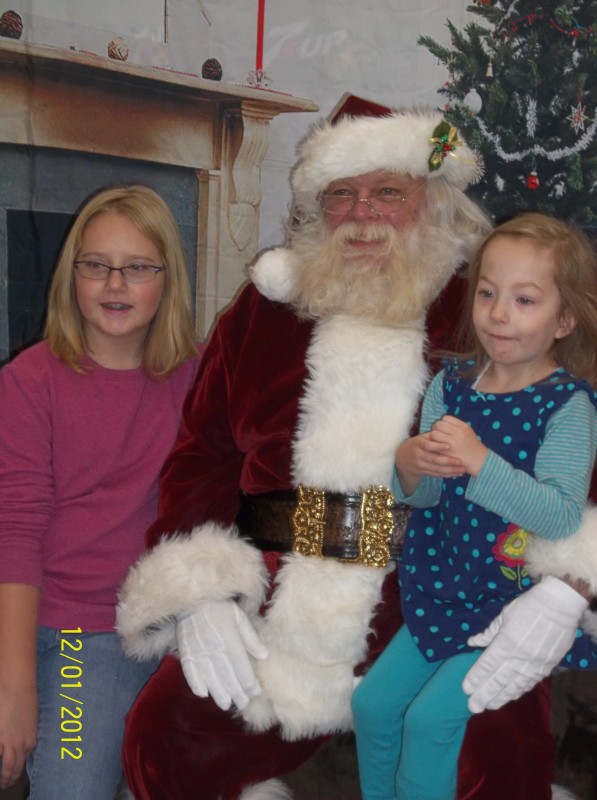 Lillie Collins, age 10, and Autumn Rogers, age 4, with Santa.