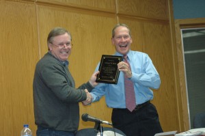 Larry Siegel, left, vice president of the Syracuse Town Council, presents town attorney Mike Reed with a plaque thanking him for his service to the town. Reed is stepping down after recently being elected as the Circuit Court Judge of Kosciusko County. (Photo by Lauren Zeugner)