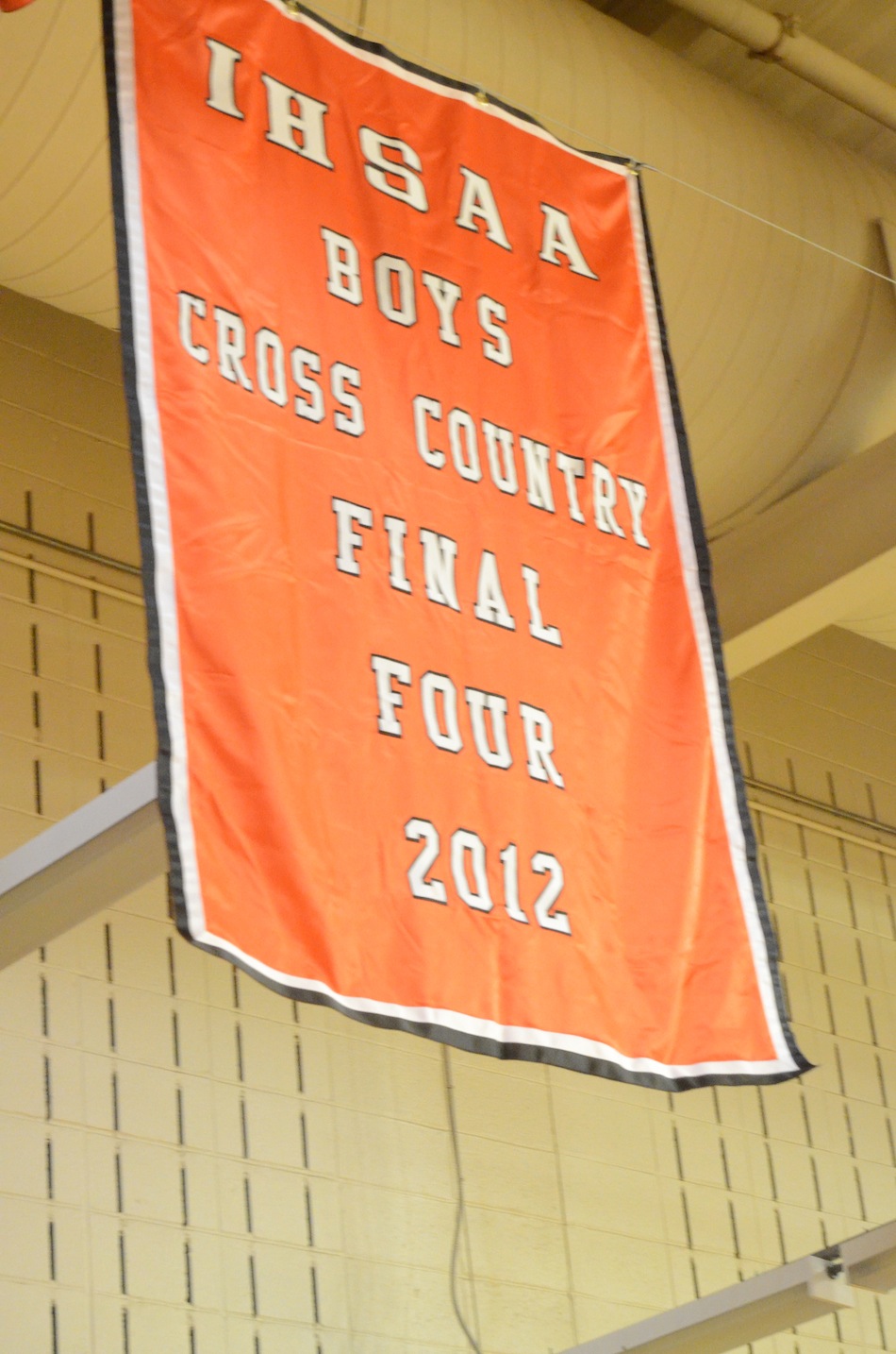 A banner honoring the outstanding season by the Warsaw boys cross country team this past fall flies in the Tiger Den after being unfurled Friday night.