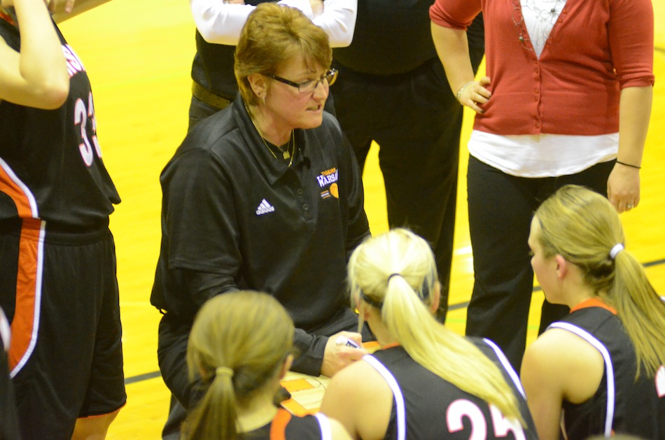 Warsaw girls basketball coach Michelle Harter talks to her team during a timeout at Northridge Saturday night. The No. 10 Tigers remained undefeated with a huge 52-39 NLC win.