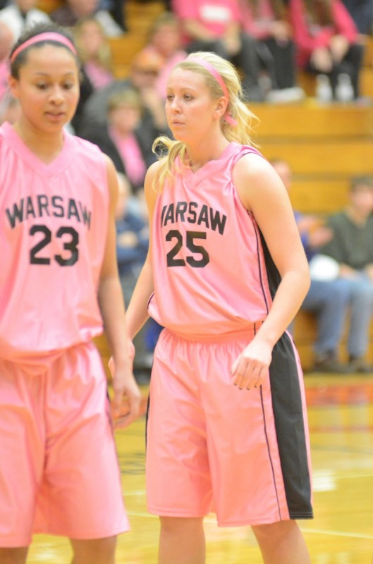 Lindsay Baker (at right) and Jennifer Walker-Crawford talk during a break in a recent game. The pair of senior stars helped Warsaw remain undefeated Saturday night with a 57-44 NLC win over Goshen.