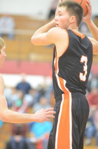 Jared Bloom protects the ball while being guarded at Goshen Friday night.