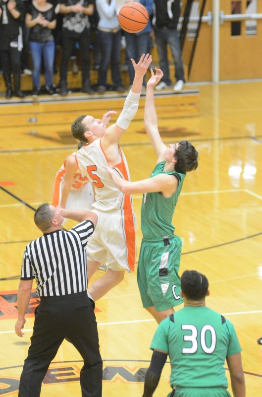 Warsaw's John Swanson (left) goes for the opening tip-off against Filip Serwatka of Concord Friday night. The Minutemen went on to post a 42-31 NLC victory.
