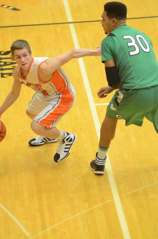 Junior guard Trae Furnivall of Warsaw works his way past Concord's Franko House Friday night at WCHS.