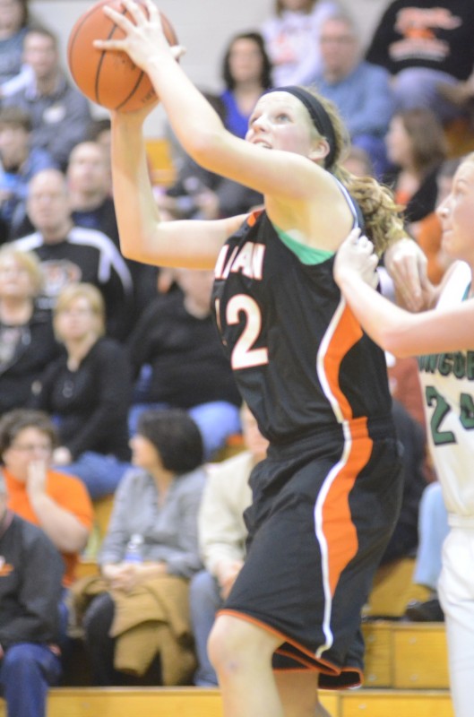 Warsaw's Nikki Grose powers inside for two of her game-high 20 points Saturday night. Grose led the undefeated Tigers to a 52-21 NLC win at Concord.