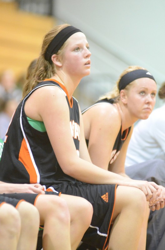 Nikki Grose and Lindsay Baker watch intently from the Warsaw bench late in the game Saturday night.