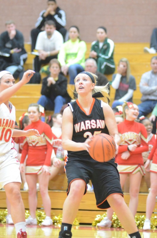Lindsay Baker drives the baseline past Paige Newvine Tuesday night at Elkhart Memorial. Baker hit five clutch free throws in the final minute as the Tigers stayed unbeaten with a huge 39-32 NLC win.