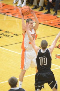 Jordan Stookey looks to pass over the defense of Tanner Farmwald Friday night. Stookey had a huge second half to lead Warsaw past NorthWood 67-51.