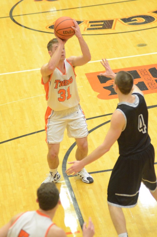 Warsaw senior Taylor Cone prepares to shoot over NorthWood's Zach Zurcher Friday night.