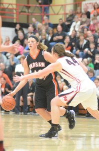 Warsaw's Nikki Grose makes a move past Morgan Olson Saturday night at NorthWood. The Tigers lost for the first time this season, 34-30 to the Panthers.