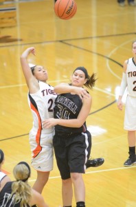 Warsaw senior standout Jennifer Walker-Crawford goes for the opening tip versus Mackenzie Kreutz of Lowell in the title game of the Lady Tiger Classic Dec. 27. The undefeated Tigers (11-0) are No. 10 in this week's Class 4-A poll.