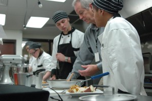 Culinary arts teacher, Dan Bauer, explains a technique to Legend Laramore and Brandon Roche. In the back are students Maranda Loetz and Jose Rodriguez. “I’ve had some of the most top notch kids in this class,” said Bauer. “There have been a few who struggle in their core classes, but excel at my class. Instead of reading books, they are experiencing hands-on learning.”
