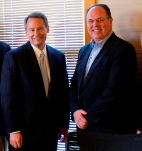From left are Walt Bettinger, CEO of Charles Schwab, Jerry Yeager, CEO of SYM Financial.