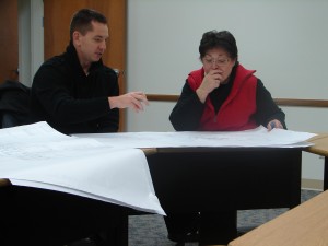 YMCA Executive Director Chad Zaucha reviews architectural renderings for a new YMCA facility with Community Foundation Executive Director Suzie Light. A Community Foundation grant for $50,000 provided the YMCA with dollars to pay for schematics for the new facility. (Photo provided)
