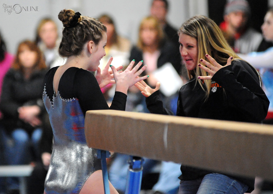 Warsaw head coach Andi Calhoun celebrates with gymnast Shannon Winslow after the sophomores beam performance at the Blazer Invite Thursday night. (Photos by Mike Deak)