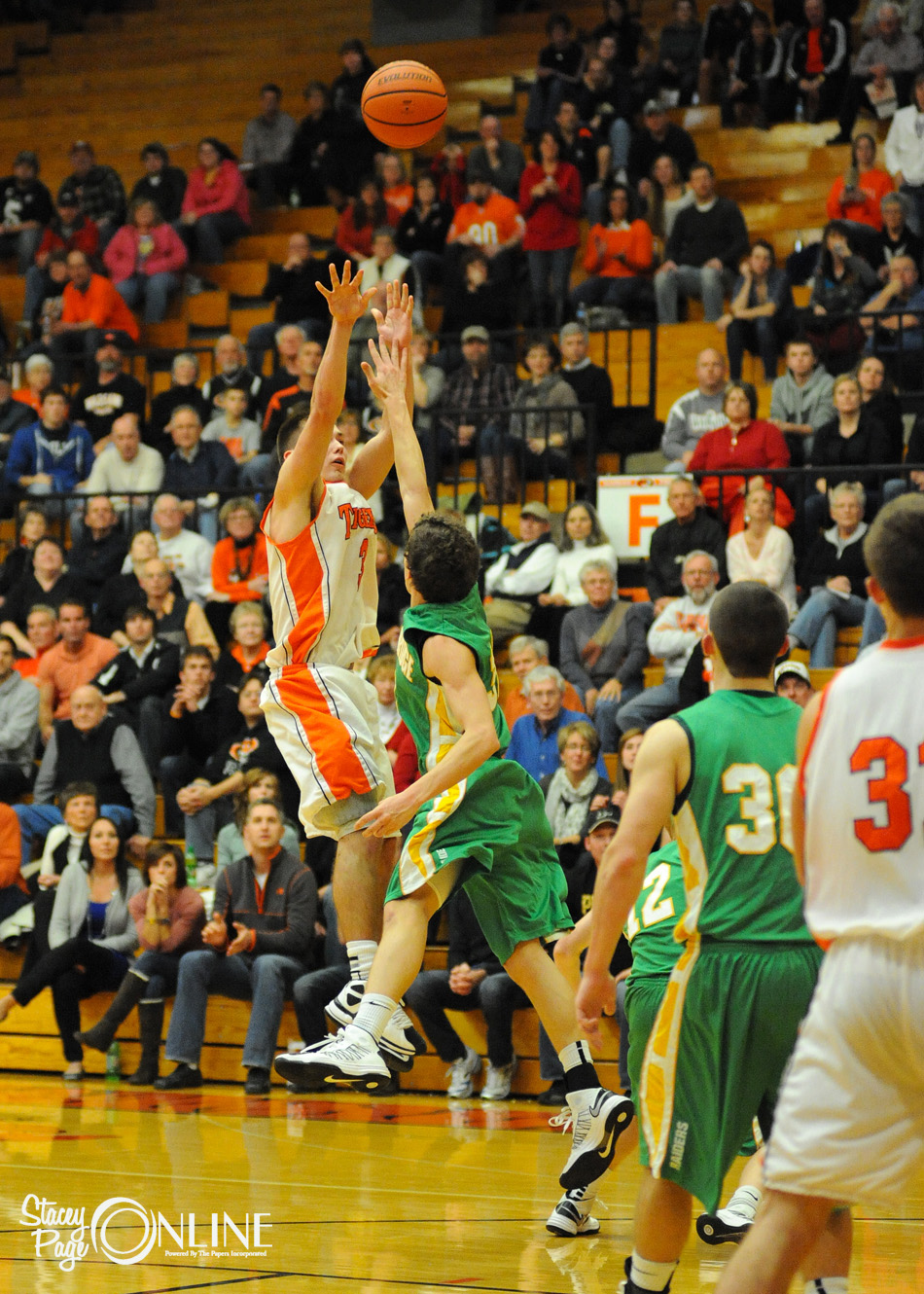 Warsaw's Jared Bloom lets fly with his game winning jumper over Joey Ganyard of Northridge Friday night. Bloom scored 25 points in a 43-41 NLC home win for the Tigers.