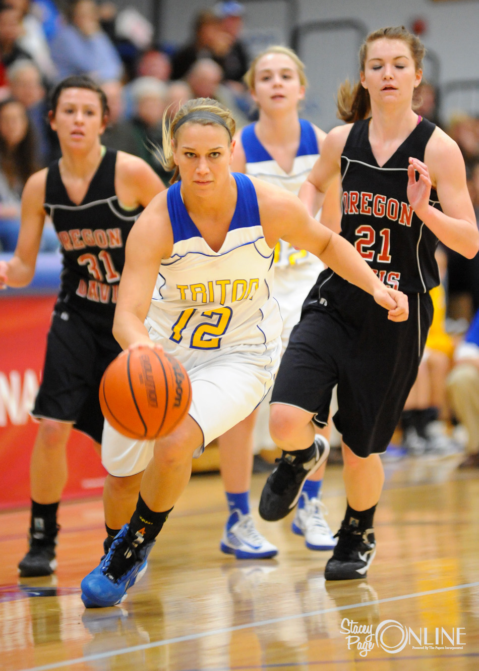 Triton's Breanna Lemler dribbles through Oregon-Davis defenders Jessica Avarone and Ashley Campbell at the girls basketball Bi-County Tournament championship Saturday night at LaVille High School. (Photos by Mike Deak)