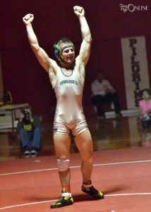 Wawasee's Nick Rozow raises his arms in triumph after winning a title at Plymouth.