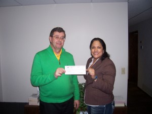Rosy Jansma presents a $1,000 donation for Tippecanoe Valley Boomerang Backpacks program to Tippecanoe Valley Superintendent Brett Boggs. (Photo provided)