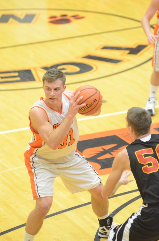 Warsaw's Taylor Cone is defended by Evan Andersen of Memorial Friday night. Cone played a strong game with 13 points and eight rebounds in a 48-47 NLC loss.