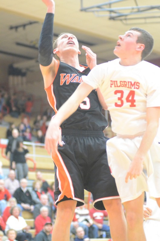 Senior John Swanson powers in two of his team-high 16 points for Warsaw over Trenton Briles of Plymouth.