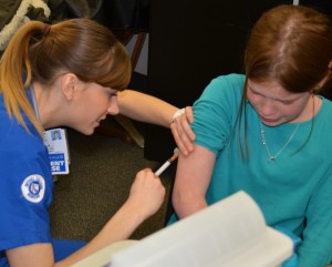 Bethel College student nurse Marla Barber administers the Varicella vaccine to Macy Wiseman in the wake of a Chicken Pox outbreak at Milford School. 