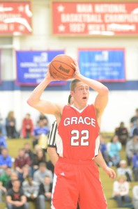 Grace College senior Elliot Smith looks to pass Tuesday night. Smith hit seven treys as the Lancers beat host Bethel 96-83.