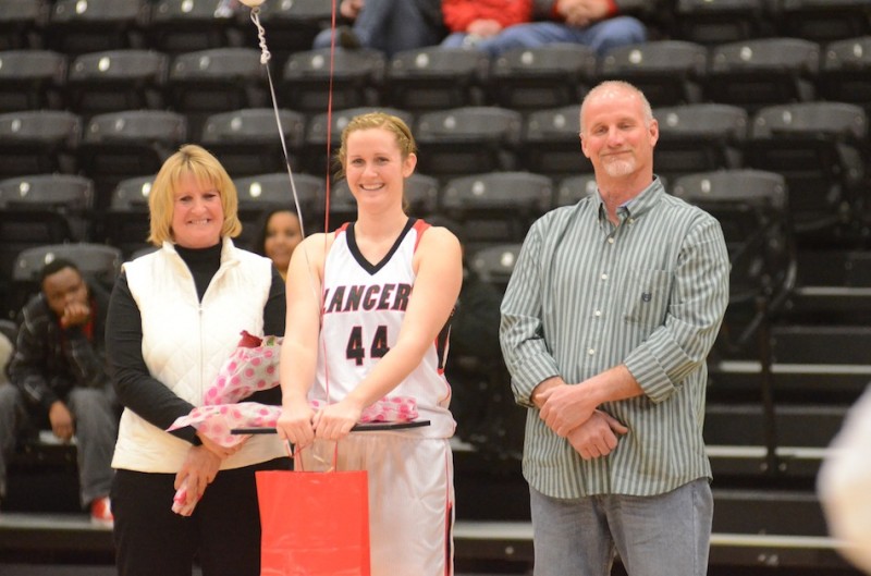 Emily Bidwell is all smiles while being honored on Senior Night Wednesday at Grace College. Bidwell, who played at Whitko High School, is flanked by her parents Pam and Brian.