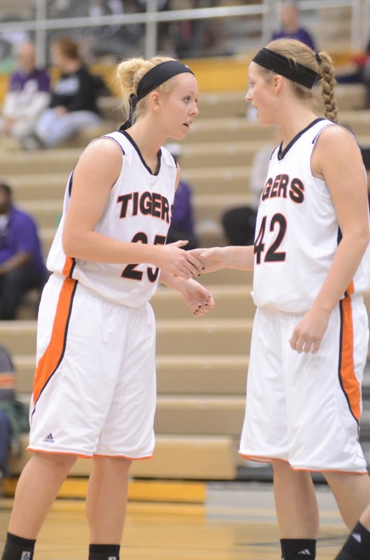 Warsaw's Lindsay Baker (left) and Nikki Grose encourage each other during regional play at Valparaiso Saturday afternoon. The pair helped the Tigers beat Penn 49-42 in a semifinal game.