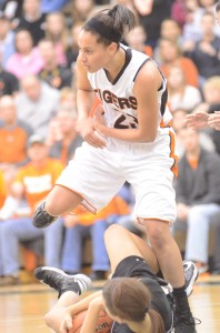 Jennifer Walker-Crawford of Warsaw battles for a loose ball versus Penn Saturday. The senior star had 10 points in Warsaw's 49-42 regional semifinal victory.