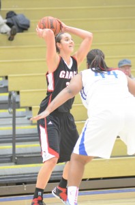 Allison Kauffman of Grace looks to pass over the defense of Baysia Cox of Bethel Tuesday night.