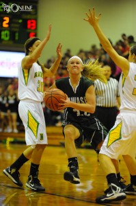 Wawasee's KiLee Knafel drives through Northridge defenders Mikaela Zook (30) and Taylor Miller Friday night at Northridge. (Photos by Mike Deak)