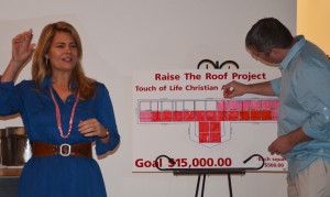 Lisa Whelchel speaks to a small crowd during a fundraising dinner Saturday night in Warsaw while Ryan Helser colors in a chart to show how much money was raised. (Photo by Stacey Page)