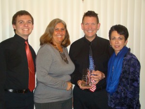 Because he had been called out of state on family business, Jay Johnson was present North Webster Person of the Year by Sue Ward, chamber president, before he left. His family Joined him for the honor. From the left are Ryan Johnson, son; Ward; Johnson; and wife, Sabrina Johnson. (Photo provided)