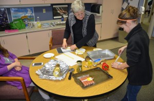 Students in Mrs. Mock's After School Adventure cooking course learn how to create snake dogs.  (photo by Alyssa Richardson)