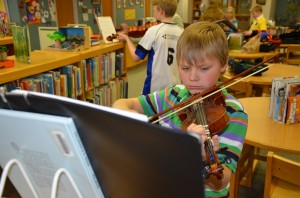 StaceyPageOnline.com and Eisenhower Junior Reporter Carson Kerlin practices his violin skills.  (photo by Alyssa Richardson)