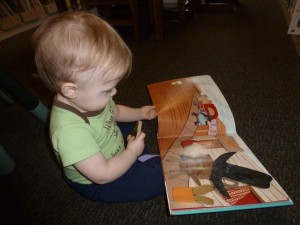 You’re never too young to enjoy a good book as one-year-old Taryn Trafan discovers during a recent trip to the Library.  (photo provided)