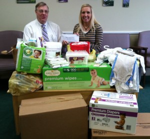 Dr. David Masterson and Emily Shipley, Development Coordinator for Heart Line, look over all of the donations made on Patient Appreciation Day.