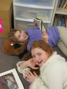 Curled up with a book and a friend, fifth graders Emma Zink and Tali Stichter are shown enjoying reading day.