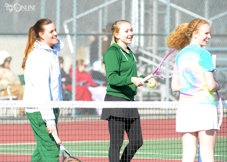 Wawasee one doubles partners Natalie Fritz (left) and Molly Smith share a laugh with Central Noble's Madeline Fair just before their opening match Thursday afternoon. (Photo by Mike Deak)