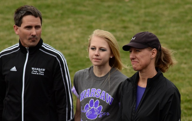 Ashley Erba (center) is honored Tuesday during Senior Night for the Warsaw girls track team. The star, who is sidelined due to a foot injury, is flanked by her parents Scott and Karen (Photos by Jim Harris)
