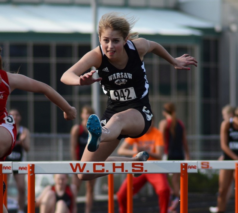 Warsaw's Brittney Rhodes flies to a second-place finish in the 100 hurdles Tuesday night (Photos by Jim Harris)